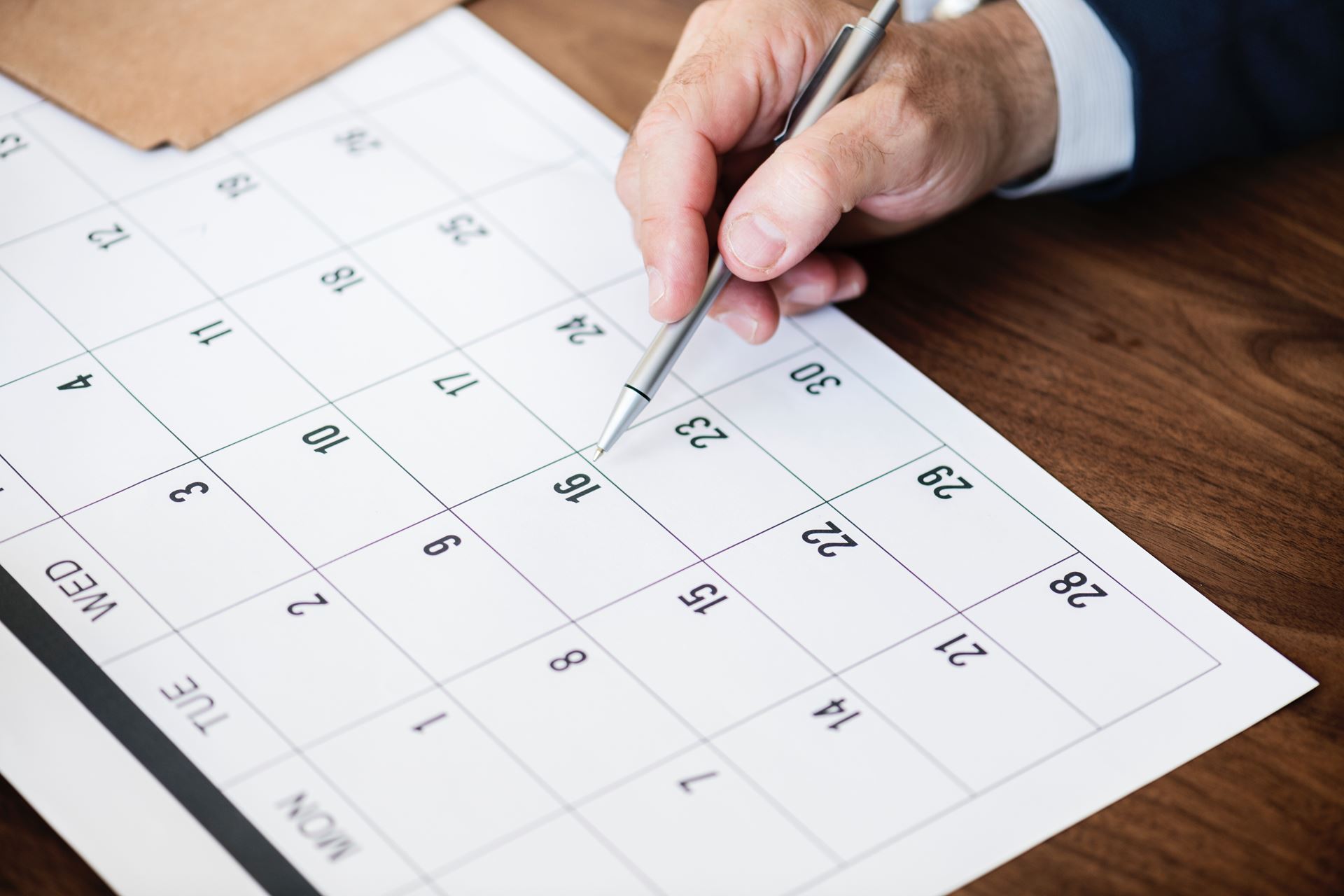 a calendar on a desk with a pen